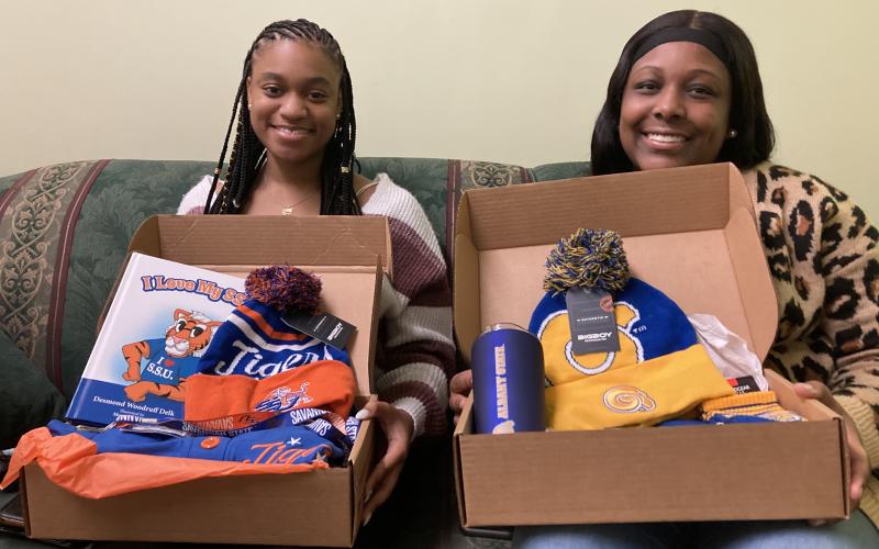 Jaylee Scott (left) and  Shakira Howard show off the contents of their College Care boxes.