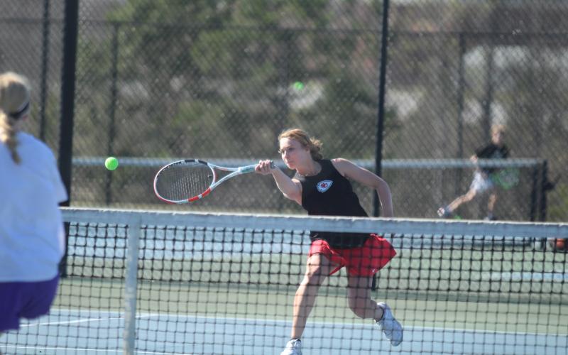 Fayeth Ivester returns the ball on the tennis court against the Monroe Area Purple Hurricanes.