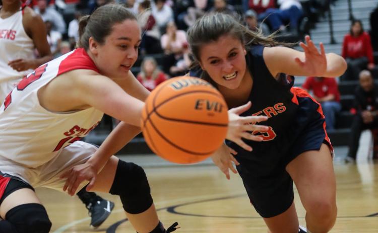 Lindsay Moore fights for a loose ball with a Habersham player. Courtesy of David Byargeon
