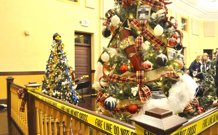 The Carnes Creek VFD tree in the foreground was the top vote-getter in this year’s Festival of Trees. Note the fire extinguisher used as a tree ornament.