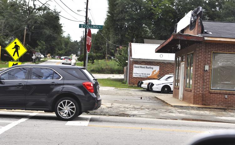 A pair of police cruisers peek out from behind the old Hemphill’s Store building being turned into a Toccoa P.D. substation. Work on the building has been delayed, city manager Billy Morse said.