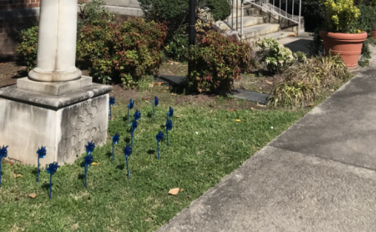 Note the pinwheels at the base of the Olympic torch in front of Toccoa City Hall. They are a reminder that April is National Child Abuse Prevention Month.