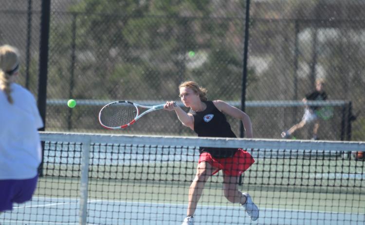 Fayeth Ivester returns the ball on the tennis court against the Monroe Area Purple Hurricanes.