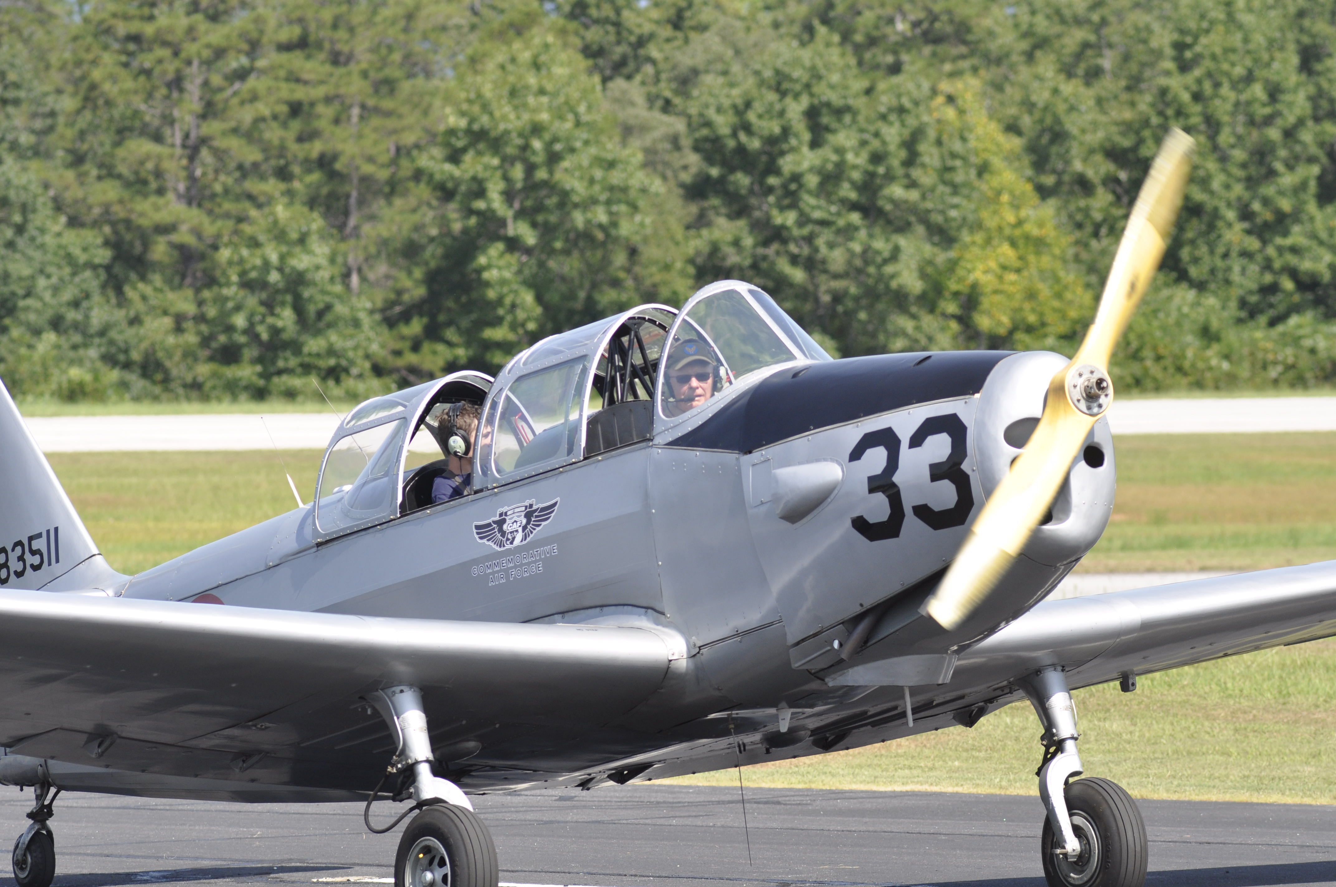 A vintage airplane with pilot George Harrison at the helm lands at the Toccoa-Stephens County Airport.