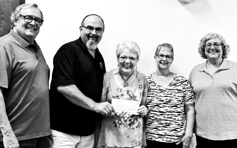 Brian Russell presents a $4,500 check