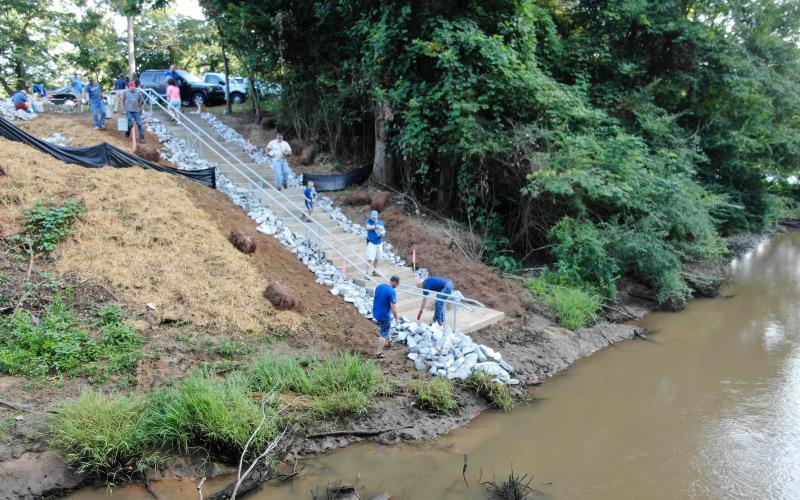 Citizens of Georgia Power put the finishing touches on stairs leading to a kayak/canoe launch site on Panther Creek at its connection with the Tugaloo River. Note the railing on the side of the steps which allows boaters to easily slide their kayaks/canoes down to the water’s edge.
