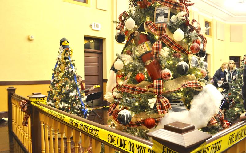 The Carnes Creek VFD tree in the foreground was the top vote-getter in this year’s Festival of Trees. Note the fire extinguisher used as a tree ornament.