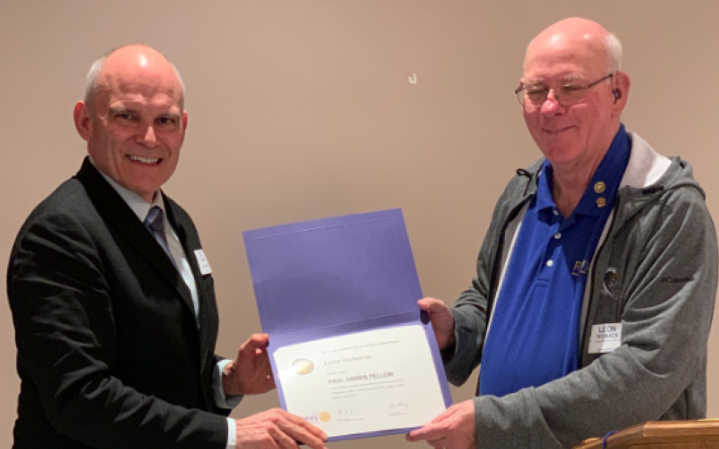 Leon Osborne (left) receives the Paul Harris Fellow designation from Toccoa Rotary Club president Leon Womack (right).
