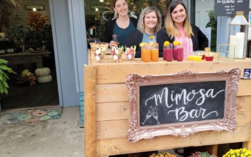 Here’s a scene from last year’s Sip-n-Stroll in downtown – Downtown Flowers hosting a Mimosa Bar.