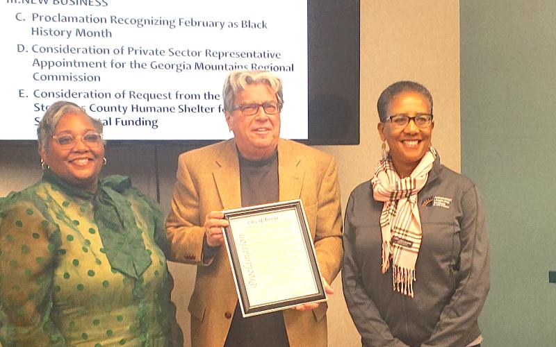 Toccoa Mayor David Austin (center) presents the Black History Month proclamation to Shantelle Grant (left) and Marie Cochran (right).