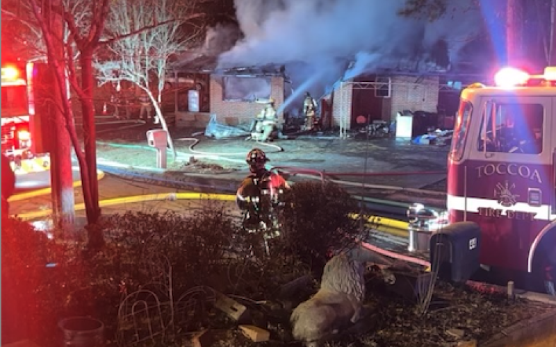 Firefighters struggle to contain a fully-involved fire at the corner of Pond and Elbertson streets.