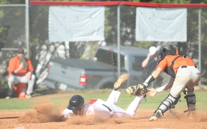 Senior Ethan Smith slides into a base during one of the Indians’ baseball games last week.