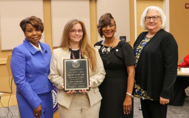 Katherine Wilcher (holding certificate)  was named Teacher of the Year by the Georgia Department of Juvenile Justice.