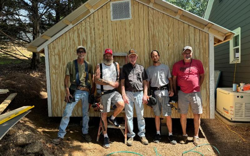 Open Arms Clinic has expanded its meidcal equipment storage shed with the held of (pictured left to right) Shannon Wigley, Tim Wilmot, Bill Stephens, Frank Moore, and Danny Yearwood.