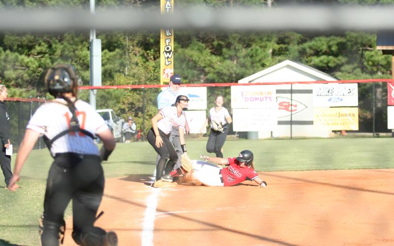 Senior Carson Stowe sliding into third during the first game in the Hart double header last week.