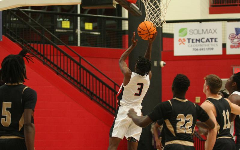CJ Harbin jumps to put the ball through the hoop in a recent game at Currahee Arena.