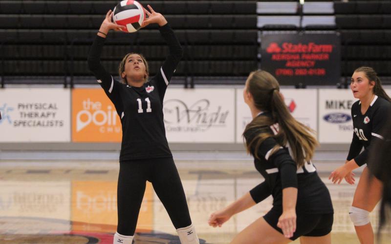 Jazzy Russell sets the ball during a game last season. Photo by Laura Shaw