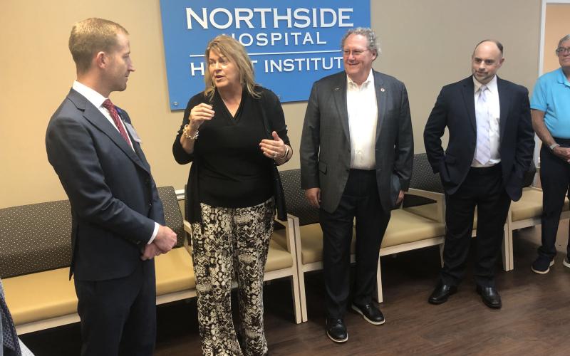 Stephens County Chamber of Commerce President Julie Paysen, second from left, talks to Stephens County Hospital CEO Van Loskoski about the new cardiology services provided by Northside Hospital Heart Institute in Toccoa as Northside Hospital cardiovascular Dr. Jeffrey Marshall and local Northside/Stephens County Dr. Mark Matthews listen to their remarks. J. Todd Truelove/The Toccoa Record