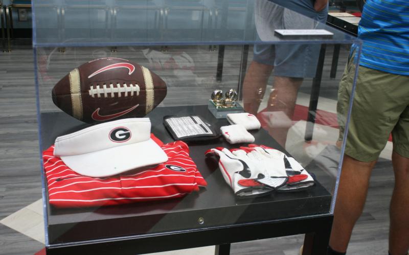 The “UGA Athletics in Your Town” display tour made a stop at the Toccoa-Stephens County Library on Friday, Aug. 1. Some of the items included in the exhibit were UGA 2’s collar, license plates, and an antique football helmet. Laura Shaw/The Toccoa Record