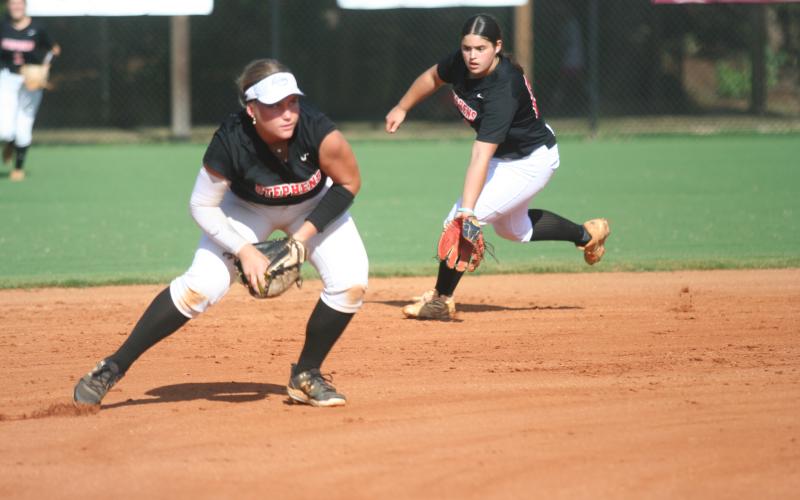 Nyleigh Hutto fields a ball on the mound while Alana Thurmond backs her up. Laura Shaw/The Toccoa Record