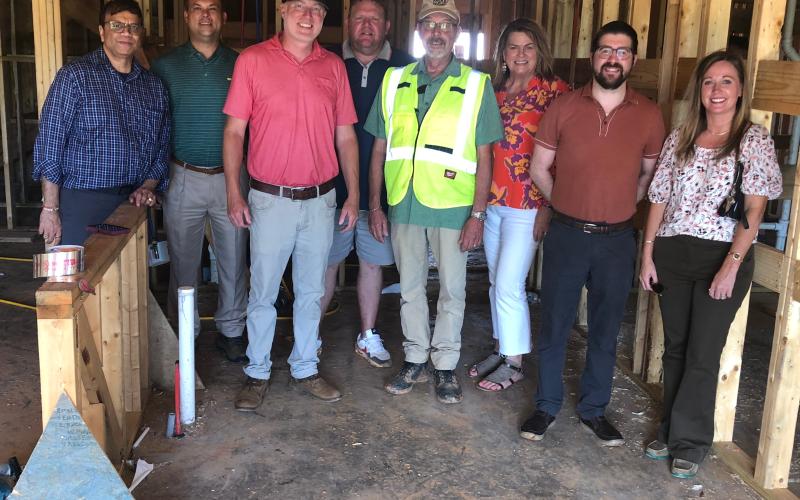 Residential development property owners recently toured and updated the status on their projects. Posing for a group shot, from left to right, on Aug. 13 are owner Bobby Shah, Stephens County Development Authority board chair Brian Akin, general contractor Ashley Hill, owner Jeremy Arrowood, construction manager Mark Gauthier, Chamber president Julie Paysen, county administrator Christian Hamilton, and Stephens County Development Authority CEO Brittany Ivey.  J. Todd Truelove/The Toccoa Record