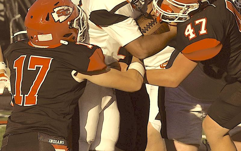 Indian defenders Hamp Holcomb (17) and Daniel Holloway (47) stop a Hart County ball carrier for little to no gain.
