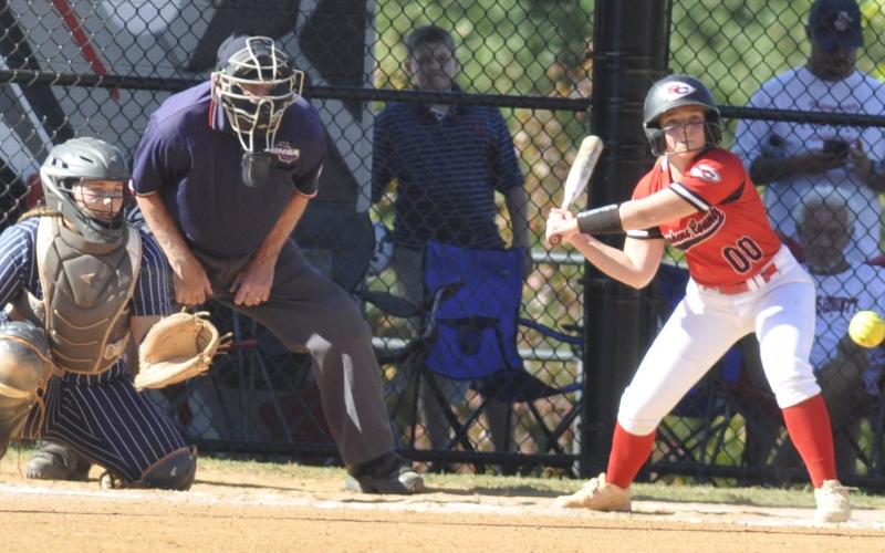 Stephens County’s Elly Hicks reaches for a low strike during state playoff action.