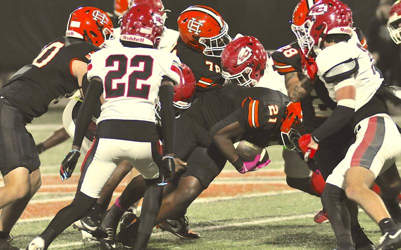 A trio of Indian defenders, including Isaiah Arthur (22), close in on a Hart ball carrier to prevent a long gain. Photo by Tom Law/The Toccoa Record.