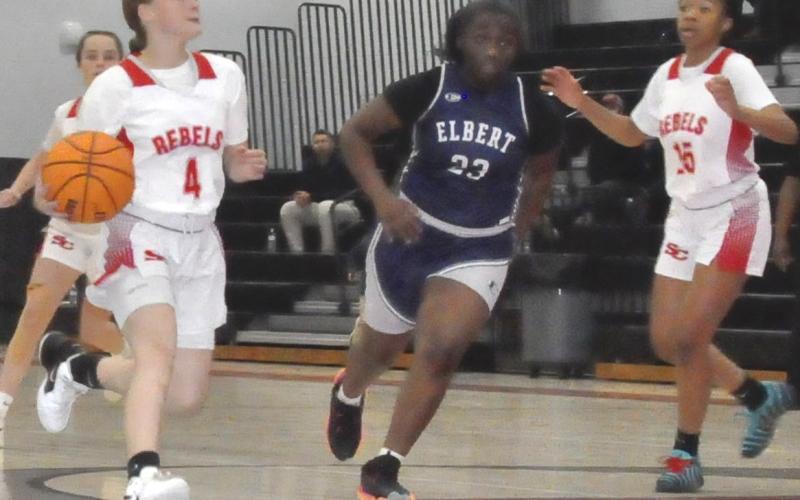 Ella Fletcher (4), left, drives to the hoop against Elbert.