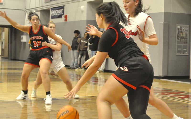 Stephens County’s Aleah Curry (30) drives to the basket as teammate Ivey Jackson (32) manuevers for the ball.