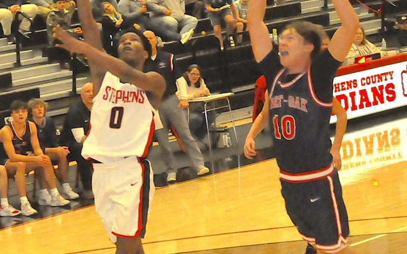 Despite the desperation shout of a West-Oak defender, Jaylen Haney (0) of the Indians registers a layup for a score.