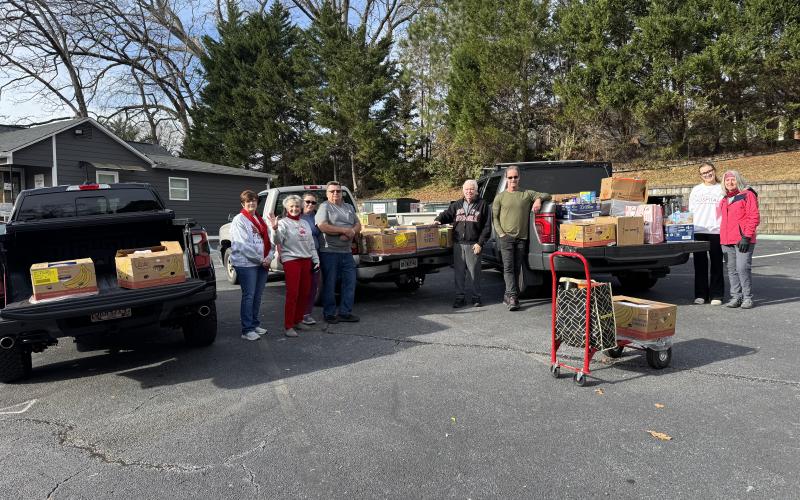Open Arms clinic held a food drive last week that resulted in 60 boxes of food being given to families in need in Stephens County. Helping with the event were North Georgia Credit Union Vice President of Credit Administration Sonya Speed, Open Arms clinic executive director Sherry Beavers, Open Arms Marketing Director Vanessa Smith, volunteer Sam Raab, volunteer George Beavers, volunteer Alan Christ, Arwen Britton, and Open Arms Clinic board member DeLisa Christ.
