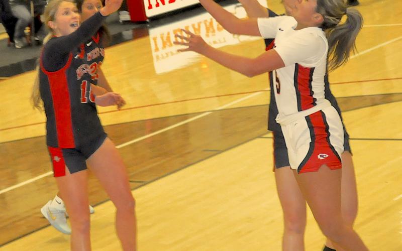 Guard Jasmine Russell (right) battles a pair of West-Oak players for posession of the basketball.