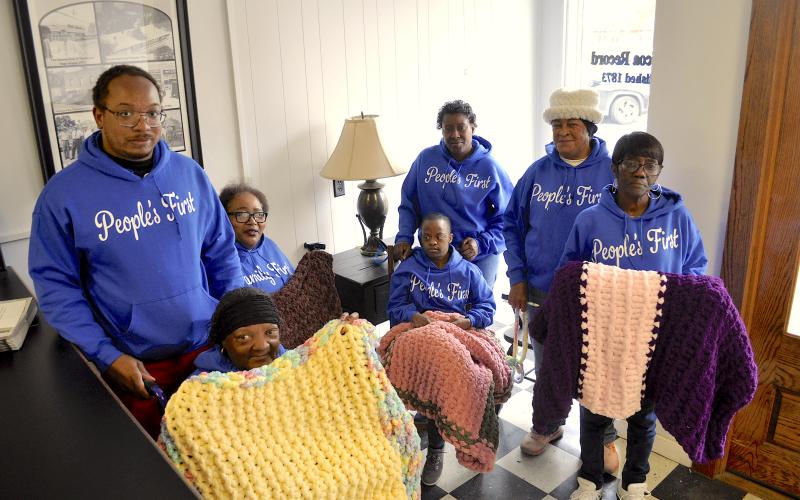 Supporters and members of the People’s First organization display some of the lap blankets made by Lanore Moore. They include (not in order) Caroline Roebuck, Dorothy Wiley, Shyresia Wiley, Tamepriacus Reese, Laura Roy, Justin Richie and Jeraldine Hayes. The blankets will be distributed to sick and elderly residents of Stephens County.