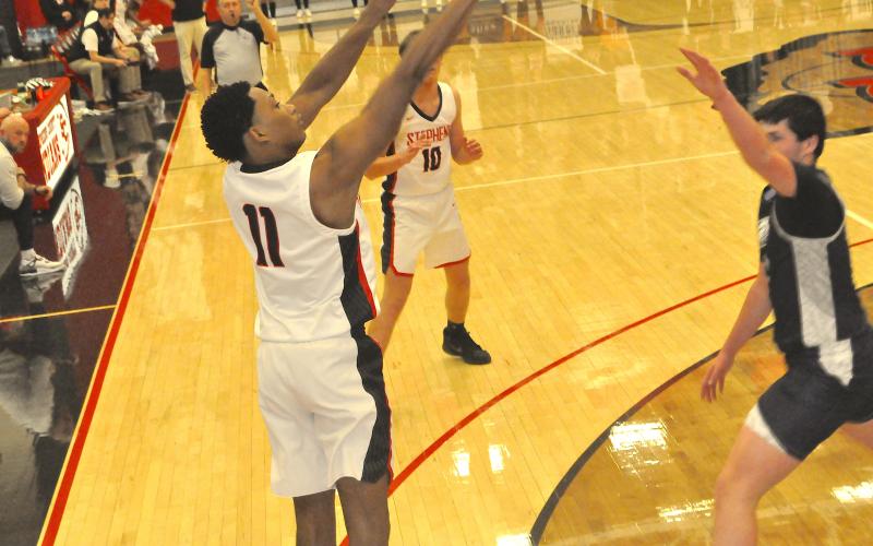 Ahmad Ivey of the Stephens County Indians launches a long range jump shot.