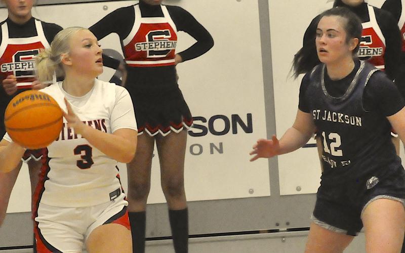 Sage Weckesser (3) looks for an open teammate breaking for the basket.