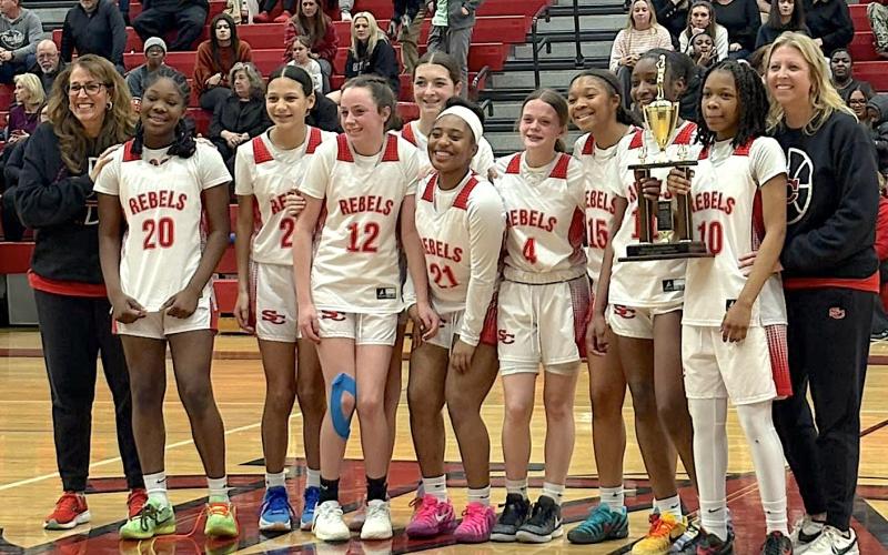 The eighth grade girls basketball team celebrates winning the conference championship after winning the season-ending tournament. Team members are (not in order) Rylee Grafton, Ella Fletcher, Jadaya Montgomery, Kiya Morgan, Emma John Crunkleton, McKennuh Merritt, Legacie Johnson, Brooke Wiley and Raquel Gunter. Head coach was Amanda Powell assisted by Delicia Fortson.