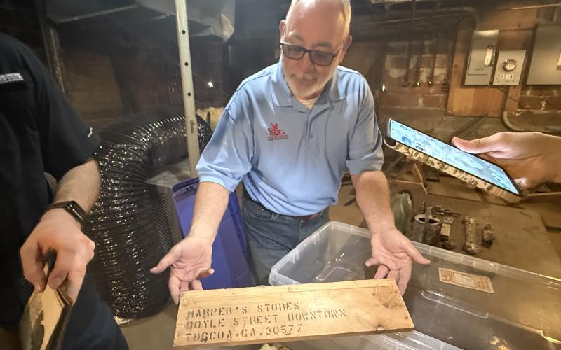 Russell Williams, of RG Williams Construction in Toccoa, shows off a piece of history he found in the old Harper's Five and 10 Cent Store.