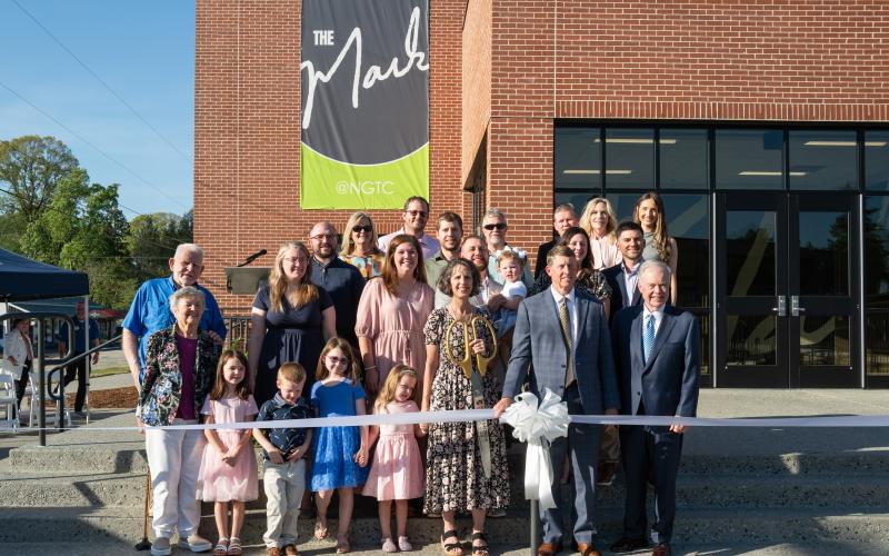 The Ivester family poses for a ribbon-cutting photo with NGTC President John Wilkinson and TCSG Commissioner Greg Dozier.