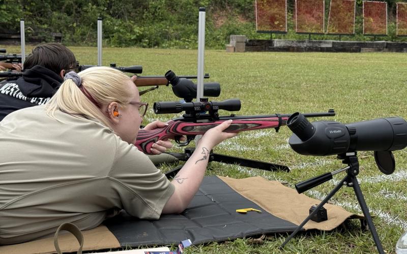 Stephens County jailer Hannah Murphy looks through the scope on her rifle at the third annual Cops v. Kids event at the Stephens County Sheriff’s Office on Saturday, May 9. The 4-H rifle team took home the prize during the competition.