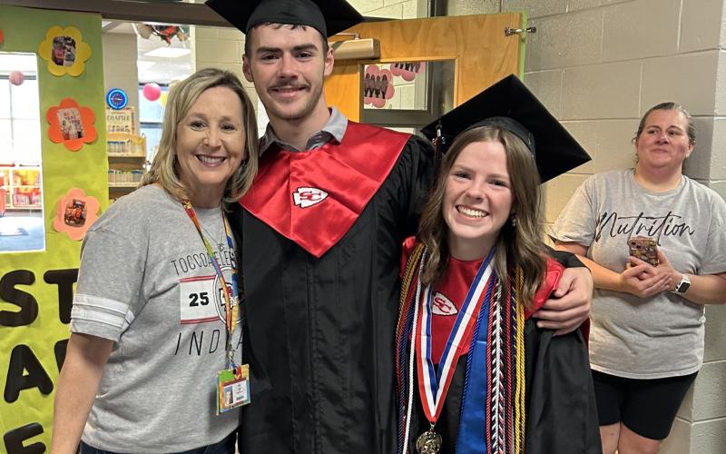 Ethan and Allyson Green, who are graduating from Stephens County High School tomorrow night, embrace their aunt, Toccoa Elementary School media specialist Amy Lee, during the traditional Senior Walk at the elementary school last week.