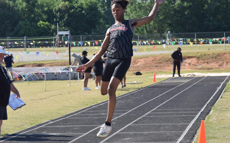 Yasir Myles makes a leap during a long jump event at a regional track meet on Saturday.