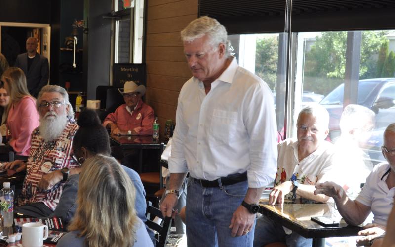 U.S. Senate candidate Mike Collins visits Bearded Bean to talk with residents.
