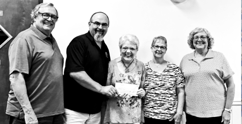 Brian Russell presents a $4,500 check