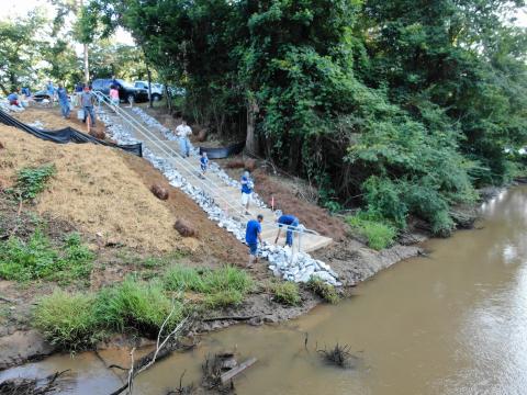 Citizens of Georgia Power put the finishing touches on stairs leading to a kayak/canoe launch site on Panther Creek at its connection with the Tugaloo River. Note the railing on the side of the steps which allows boaters to easily slide their kayaks/canoes down to the water’s edge.