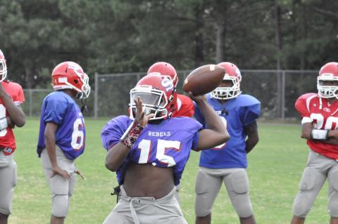 Rebel quarterback Javin Gordon loads up to fire a pass. The seventh grader is expected to operate the Rebel offense this season.