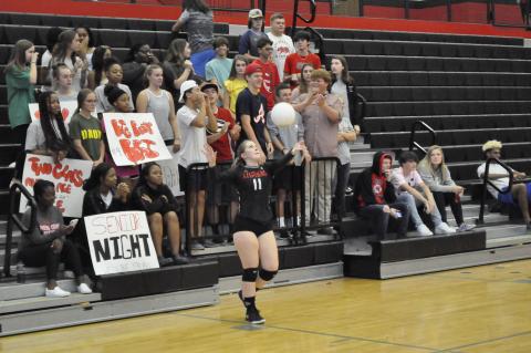 Lydia Cornelius serves during senior night 