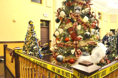 The Carnes Creek VFD tree in the foreground was the top vote-getter in this year’s Festival of Trees. Note the fire extinguisher used as a tree ornament.