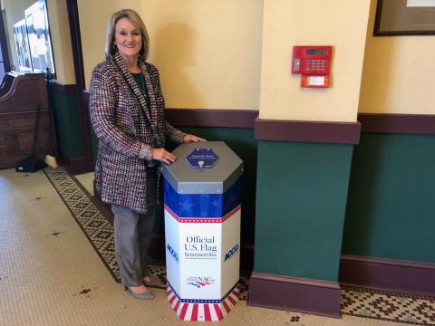 County clerk Beth Rider with the new flag disposal box.