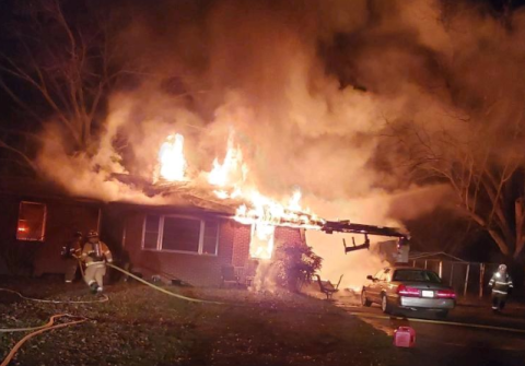 Flames erupt from a house on Old Brookhaven Circle early Monday.